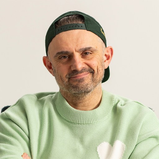 A man in a green sweater with his arms crossed.
