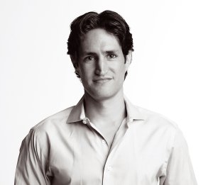 a black and white photo of a man in a dress shirt.