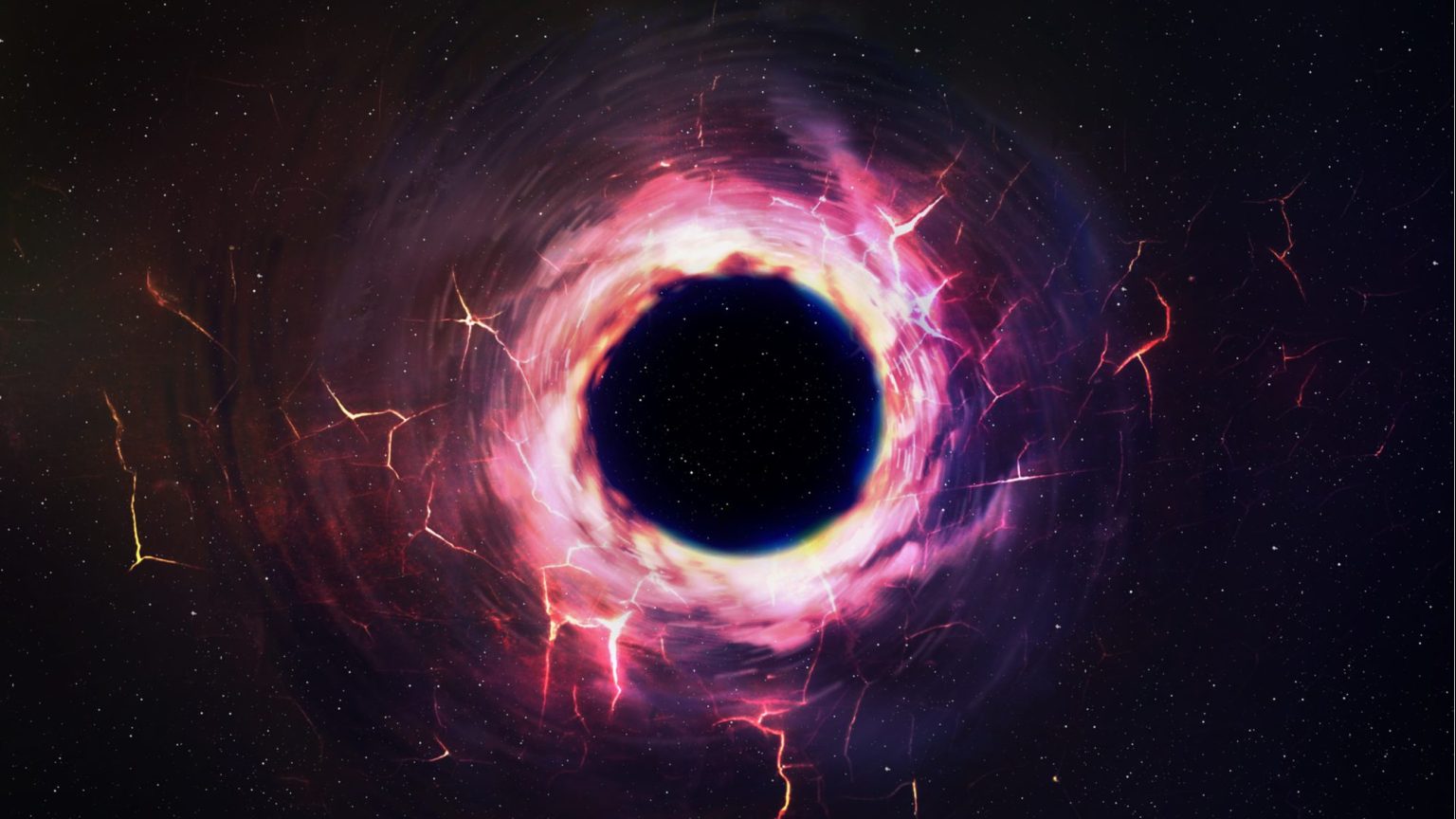 Even in the complete absence of external matter, black holes aren't completely dark, as a very small amount of low-energy radiation gets emitted due to quantum processes: Hawking radiation. Whether or not this radiation preserves and encodes all of the information that went into creating and growing the black hole has not yet been determined. This is the heart of the black hole information paradox.