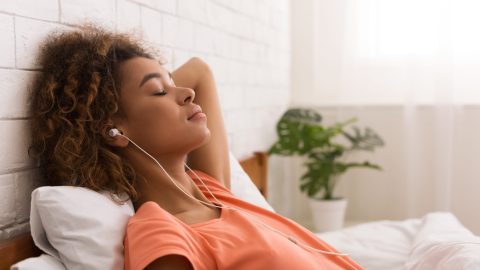 Women relaxes while listening to music.