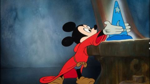 Mickey Mouse reaches for the magical hat in The Magician's Apprentice.