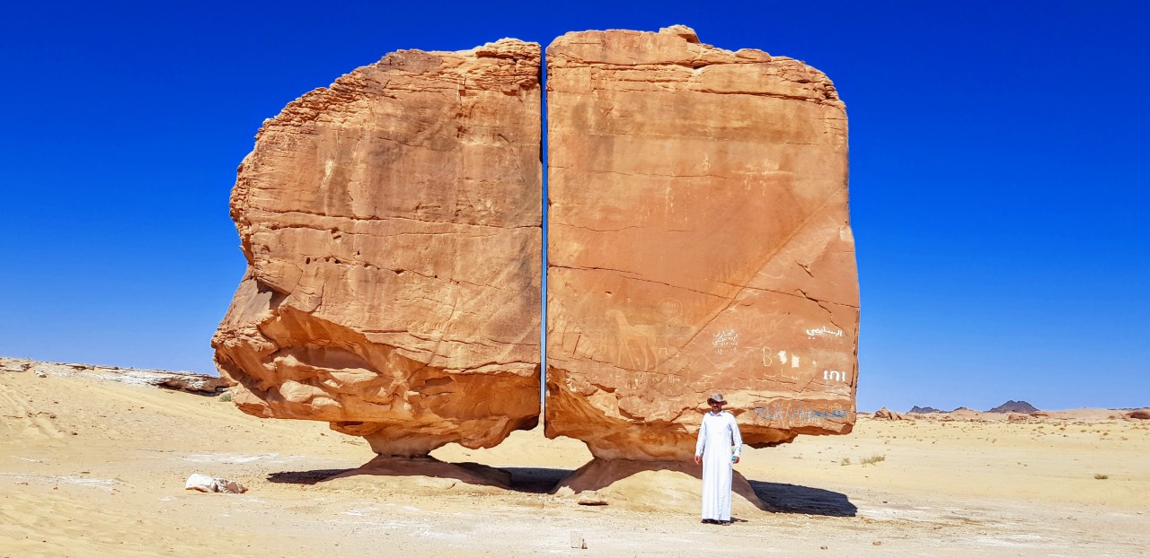 Tourist standing next to al Naslaa. Photo: Big Think
