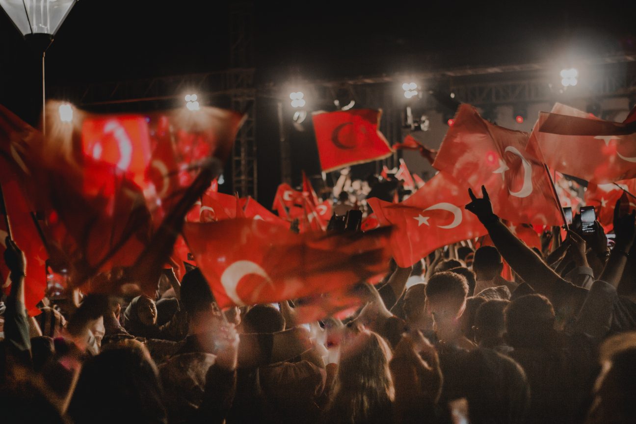 People wave the Turkey flag at a night concert.