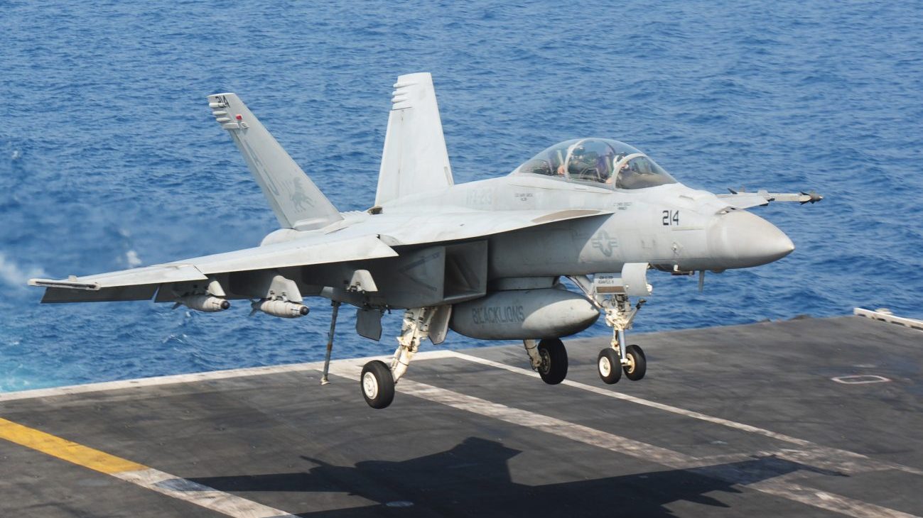 An F/A-18F Super Hornet prepares to land on the flight deck of the aircraft career USS George H.W. Bush.