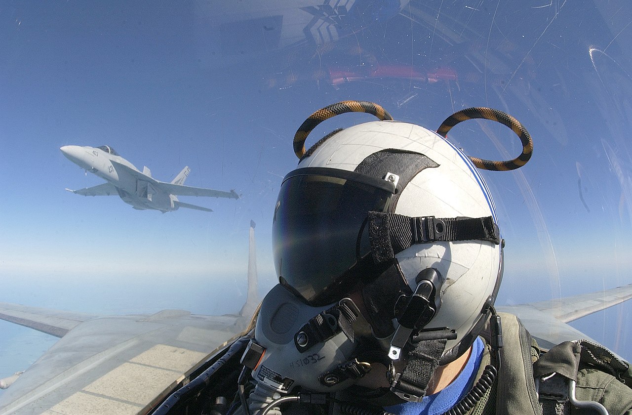 A radar intercept officer in an F-14B Tomcat looks over his shoulder at another of the squadron's aircraft.