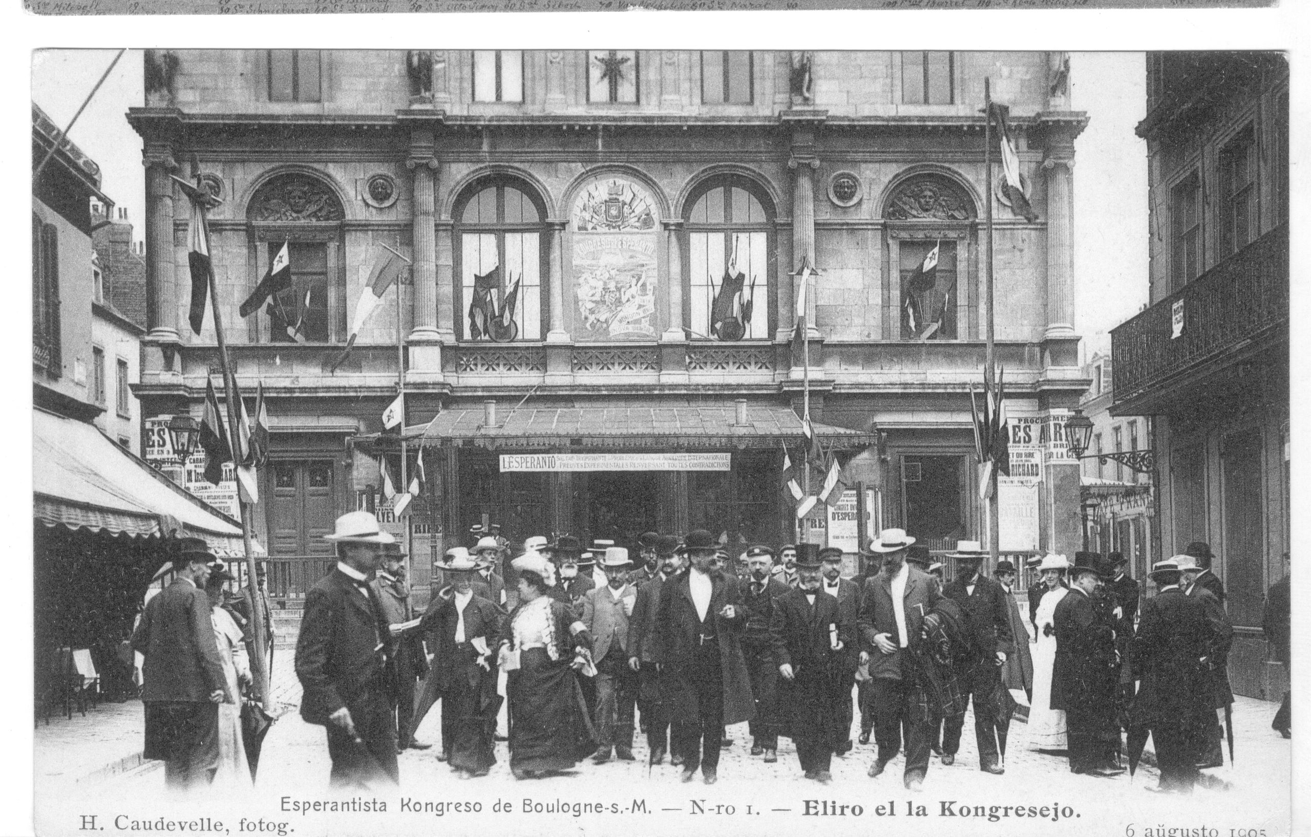 a group of men standing in front of a building.