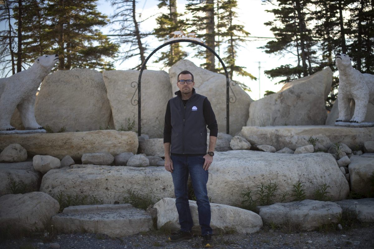 a man standing in front of some rocks.