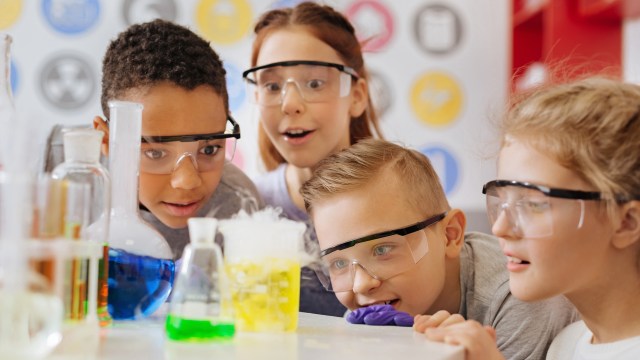 a group of kids wearing glasses in a lab.