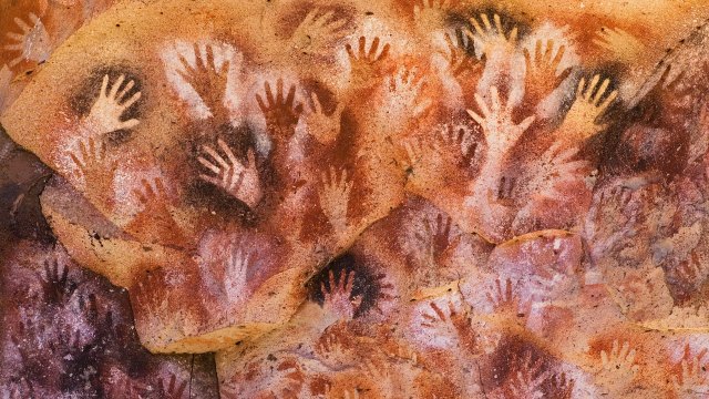 a group of hand prints on a rock.