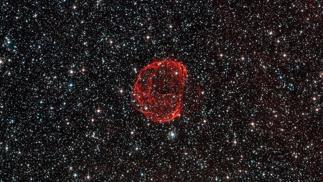 a red object in the middle of the night sky.