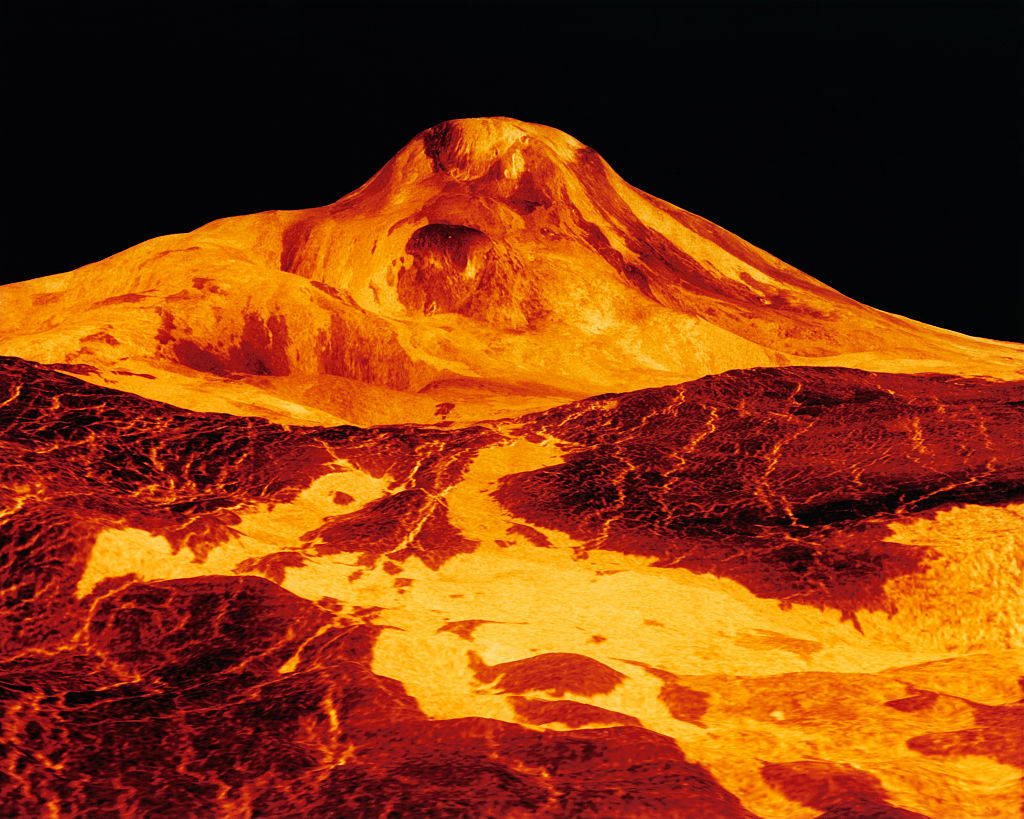 a very large mountain with a very bright orange top.