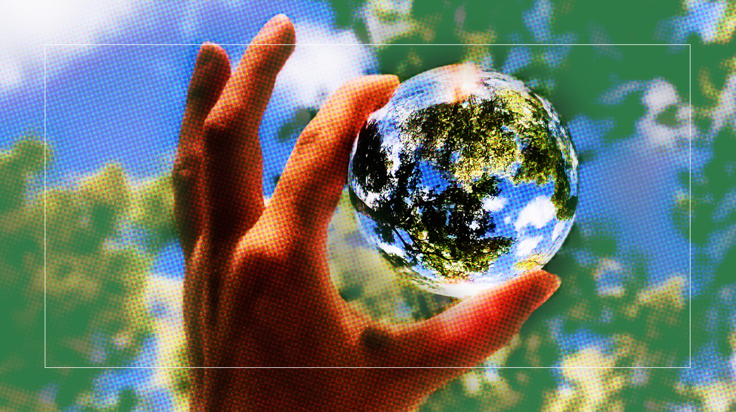 a person holding a glass ball in their hand.