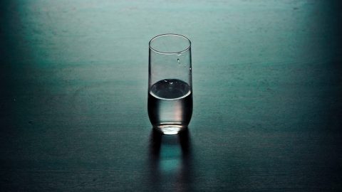 a glass of water sitting on a table.