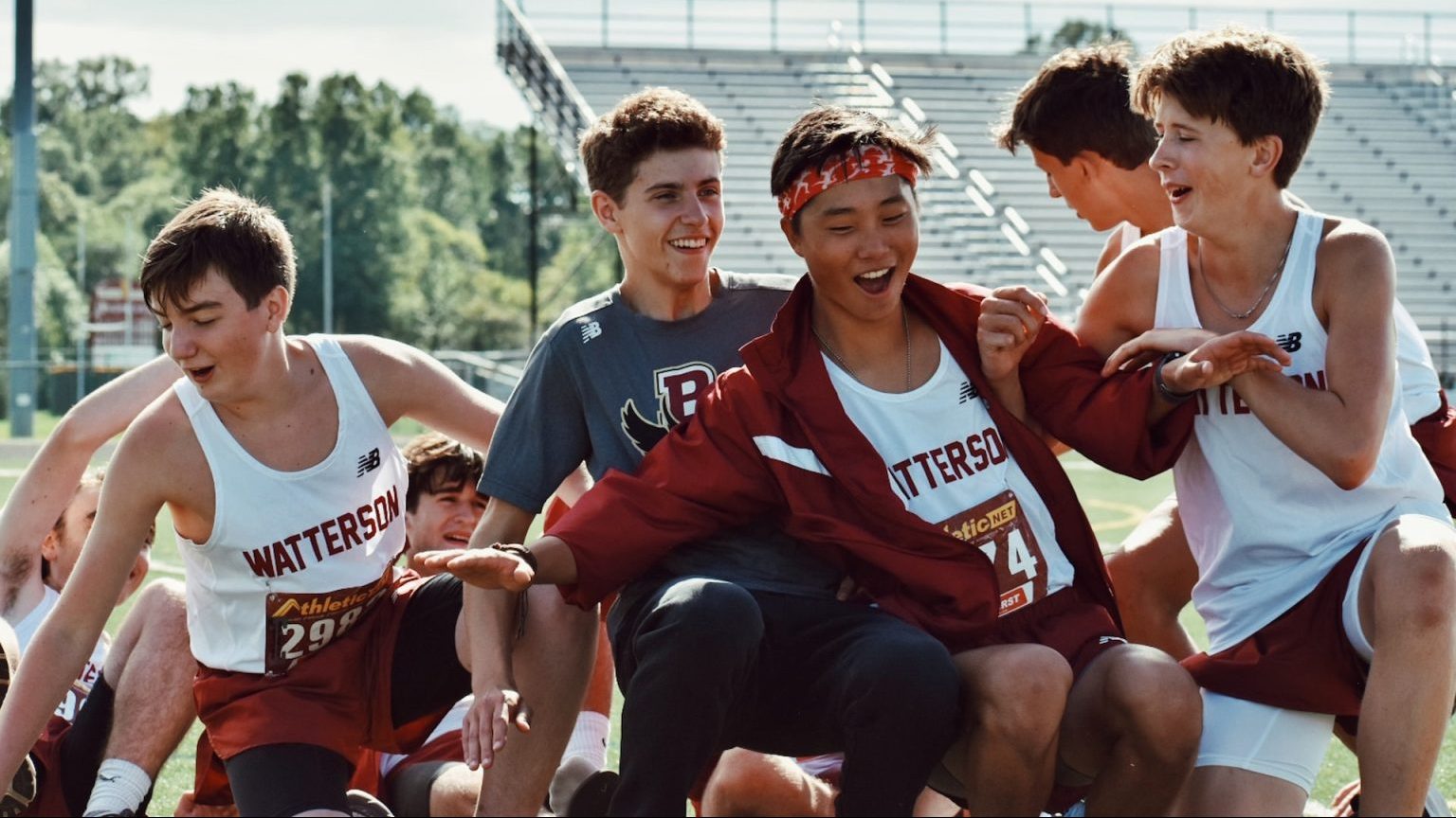 a group of young men standing next to each other on a field.