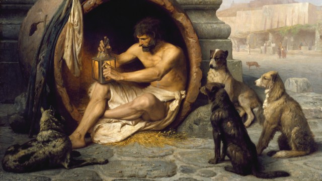 a painting of a man sitting in a cave surrounded by dogs.