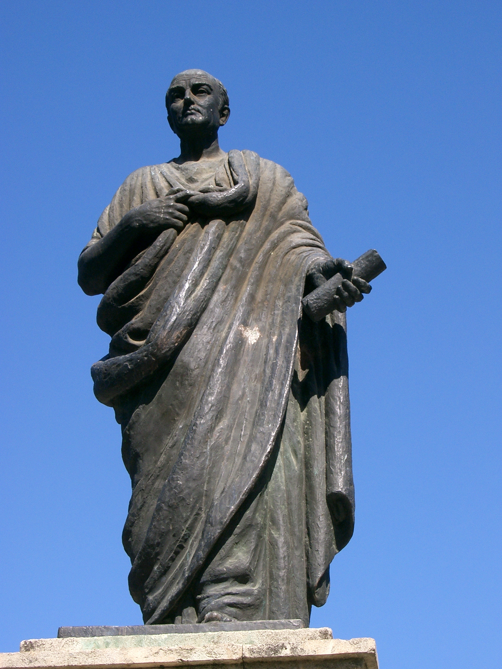 A statue of Seneca with a book in his hand.