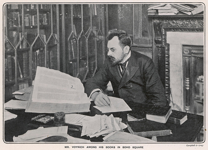 a black and white photo of a man sitting at a desk.