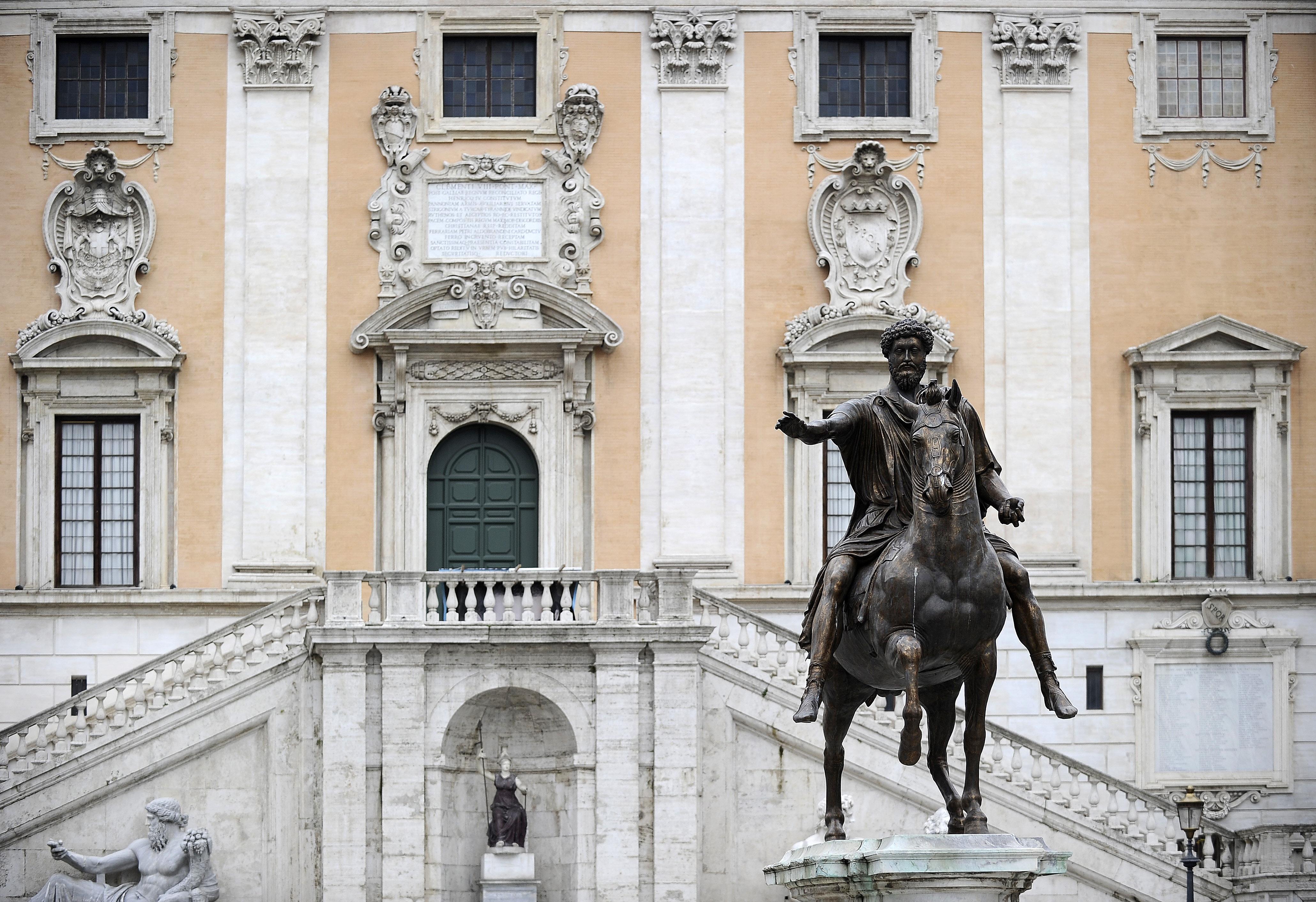 A statue of Marcus Aurelius on a horse in front of a building.