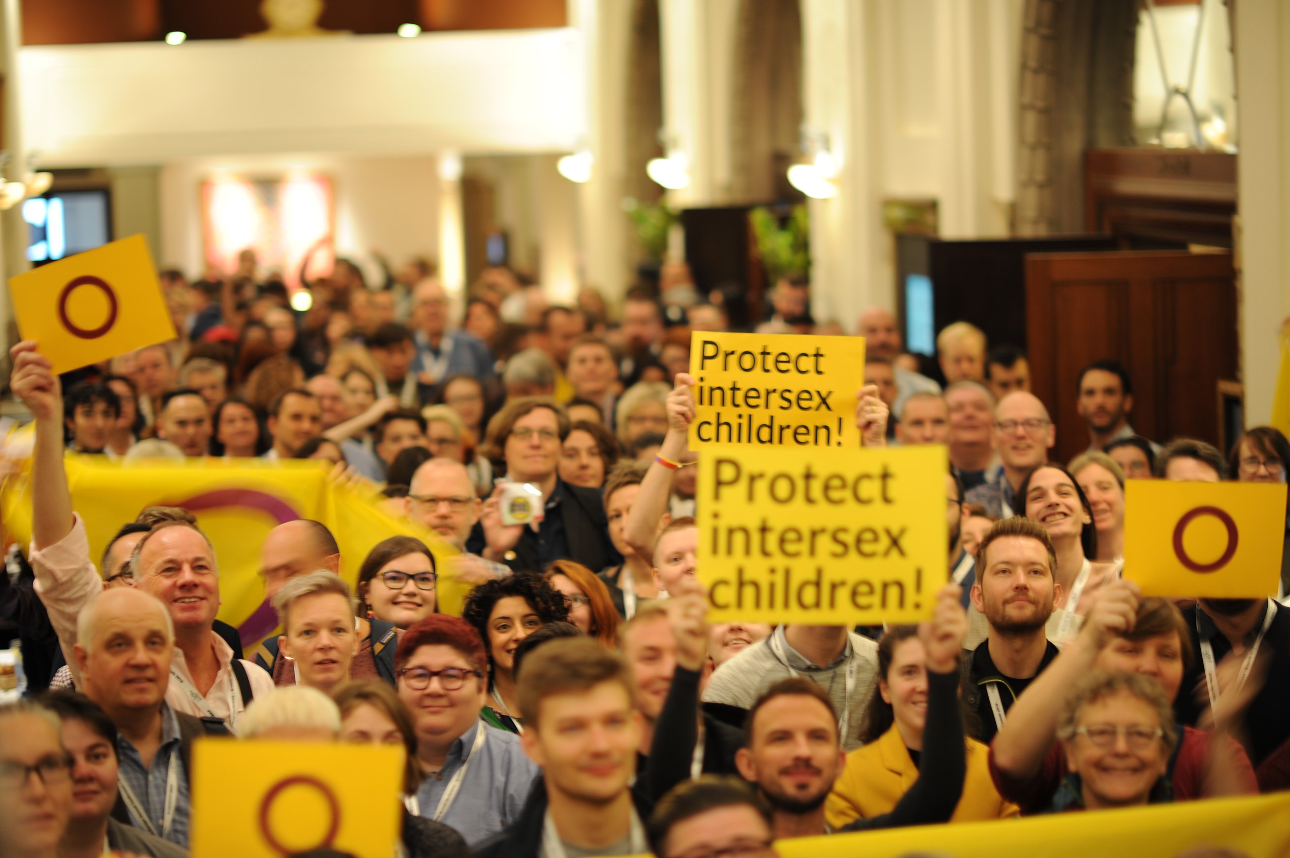 a large group of people holding up signs.