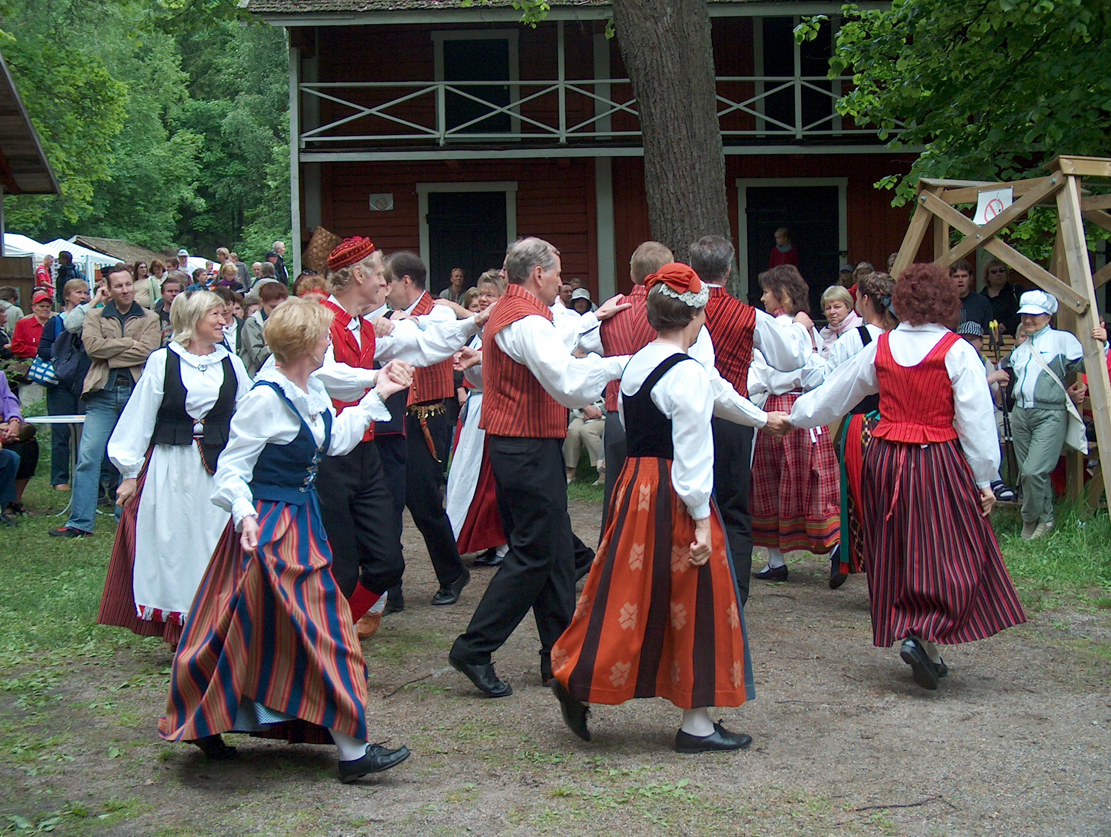 A group of people dancing in front of a building.