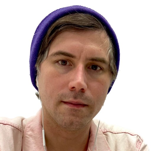 a man wearing a purple beanie and earphones.