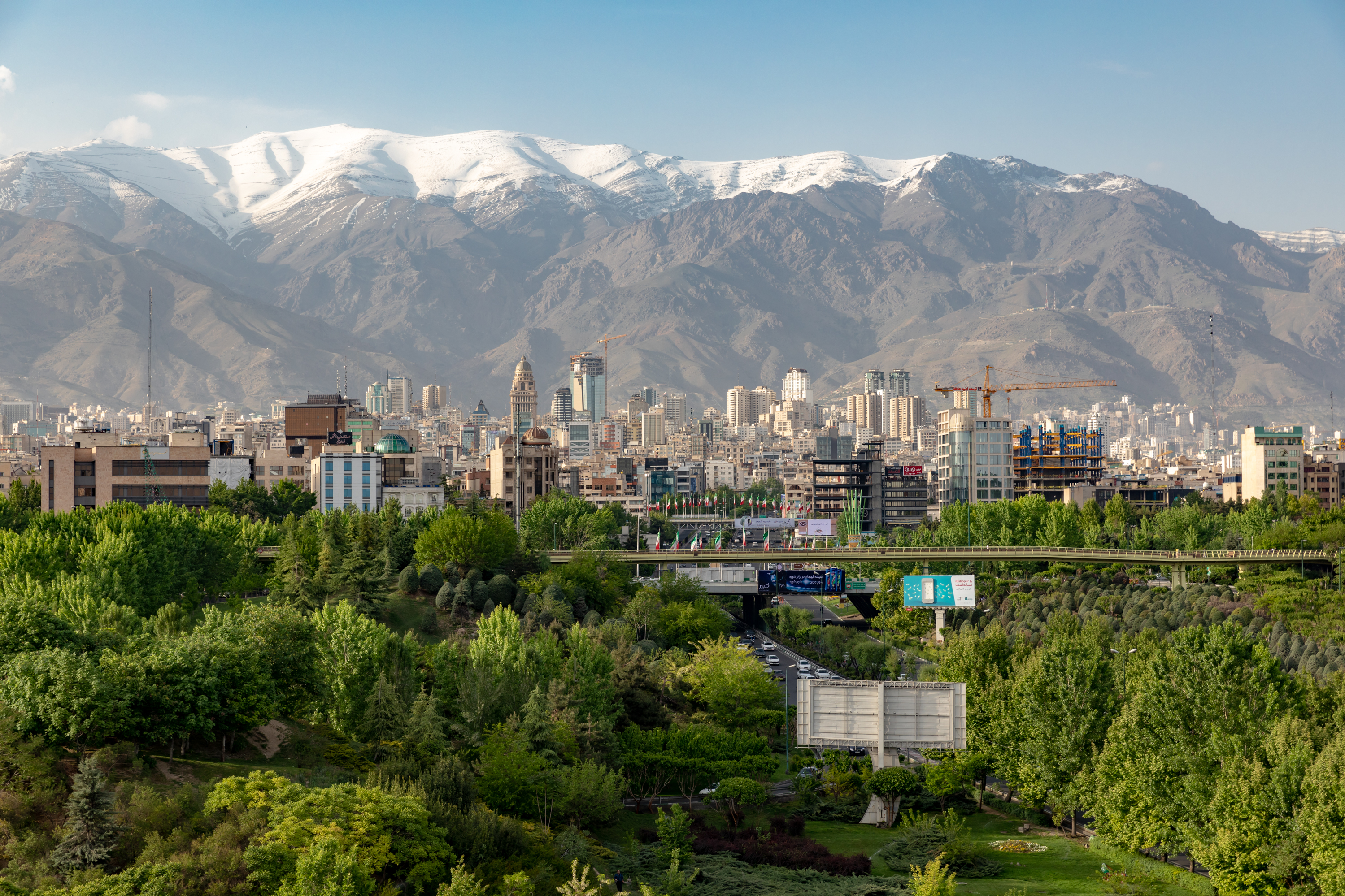 The city of Tehran, juxtaposed with snow-capped mountains in the background.
