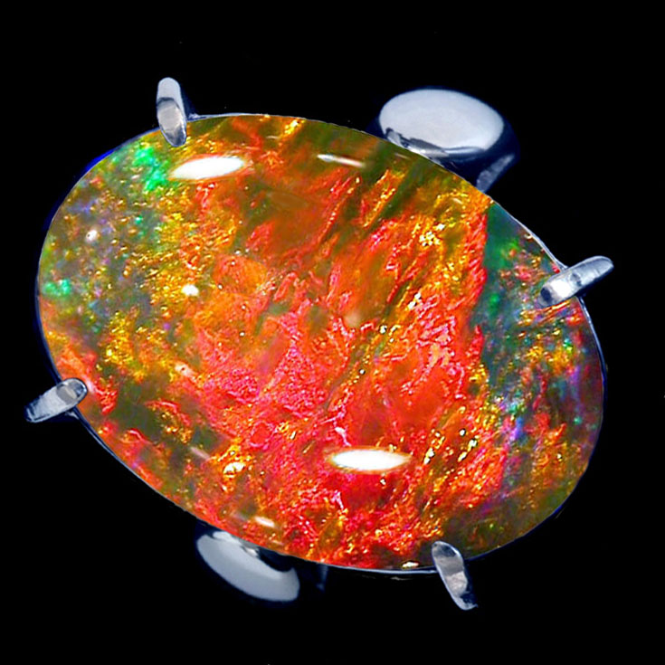 Oval-shaped opal on a black background.