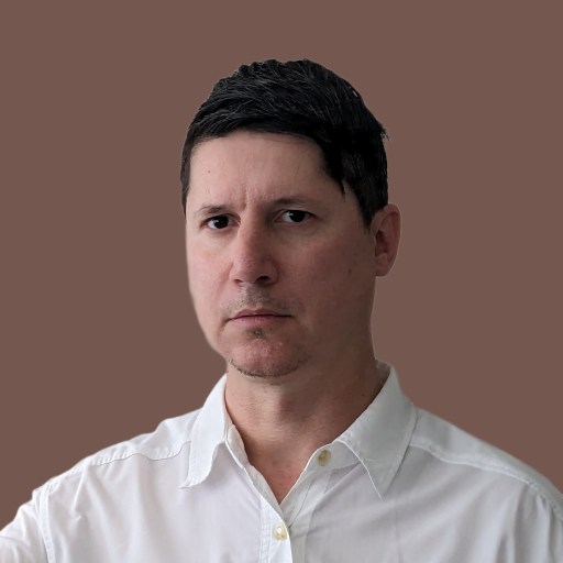 a man in a white shirt is pointing at a brown background.