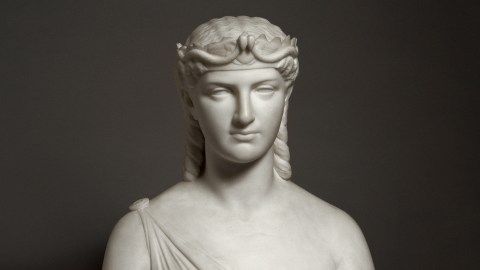 A bust of Cleopatra, the woman wearing a crown.