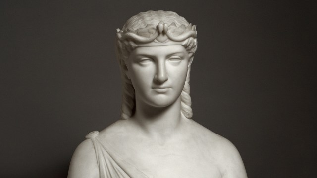 A bust of Cleopatra, the woman wearing a crown.