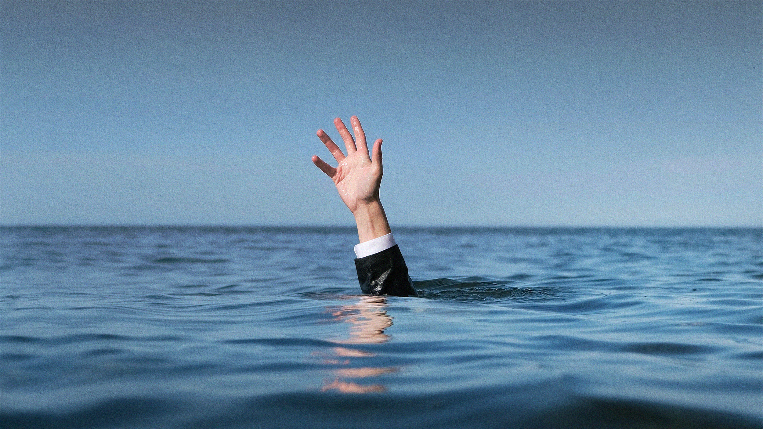 A middle manager's hand emerging from the water.