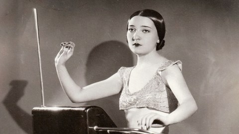 An old photo of a woman holding a theremin.