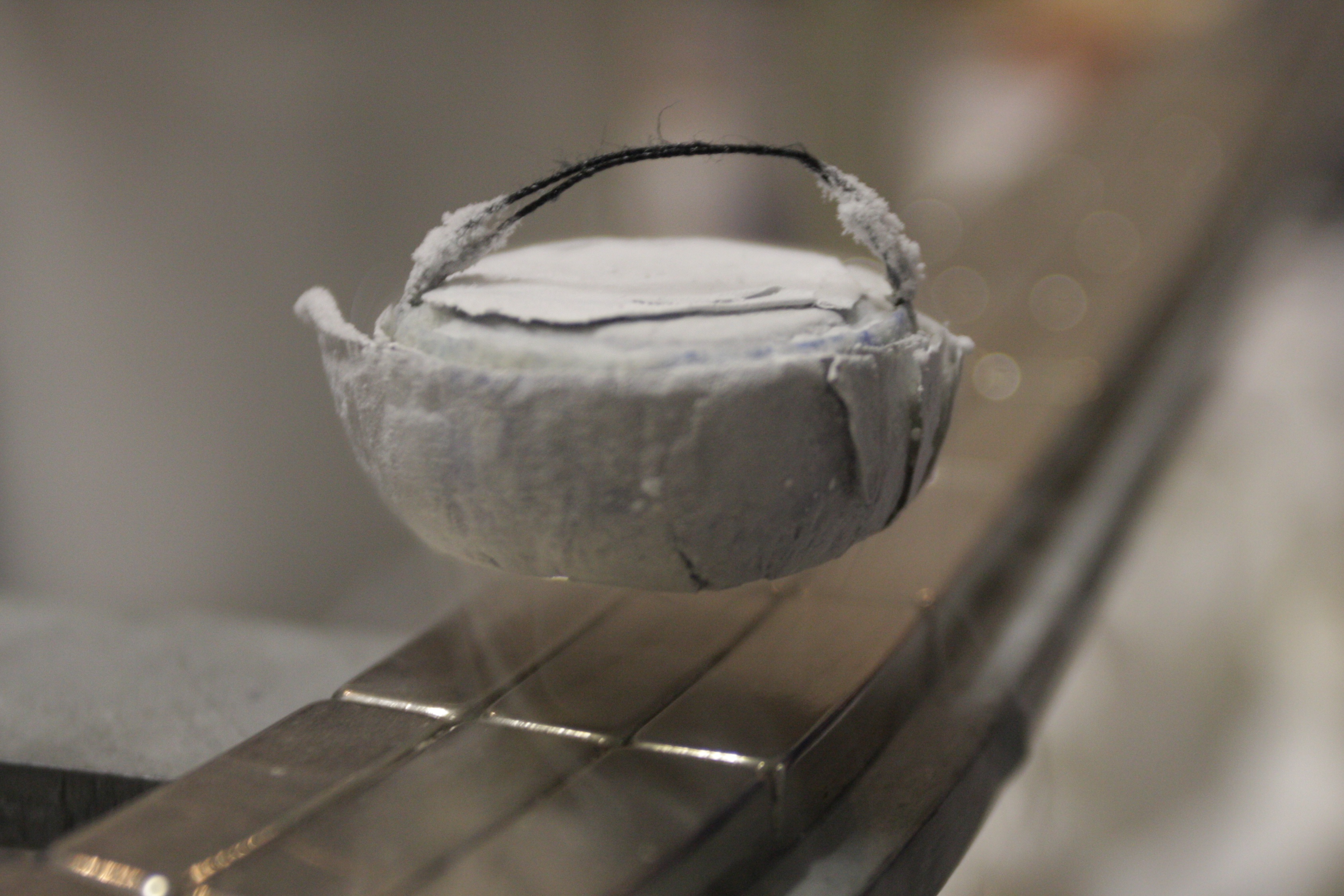 A metal railing supporting a white basket.