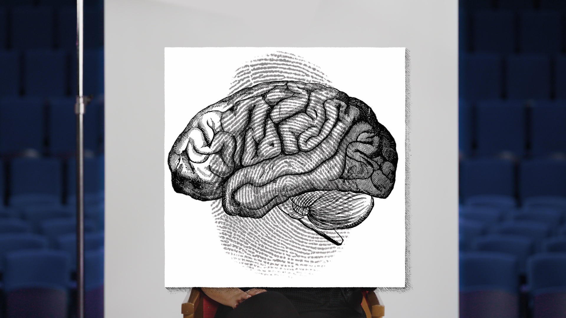 A poster with a drawing of a brain in front of an auditorium.