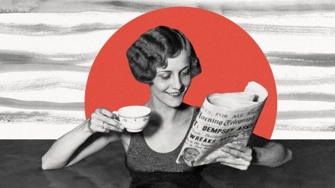 A woman reading news with a cup of coffee.