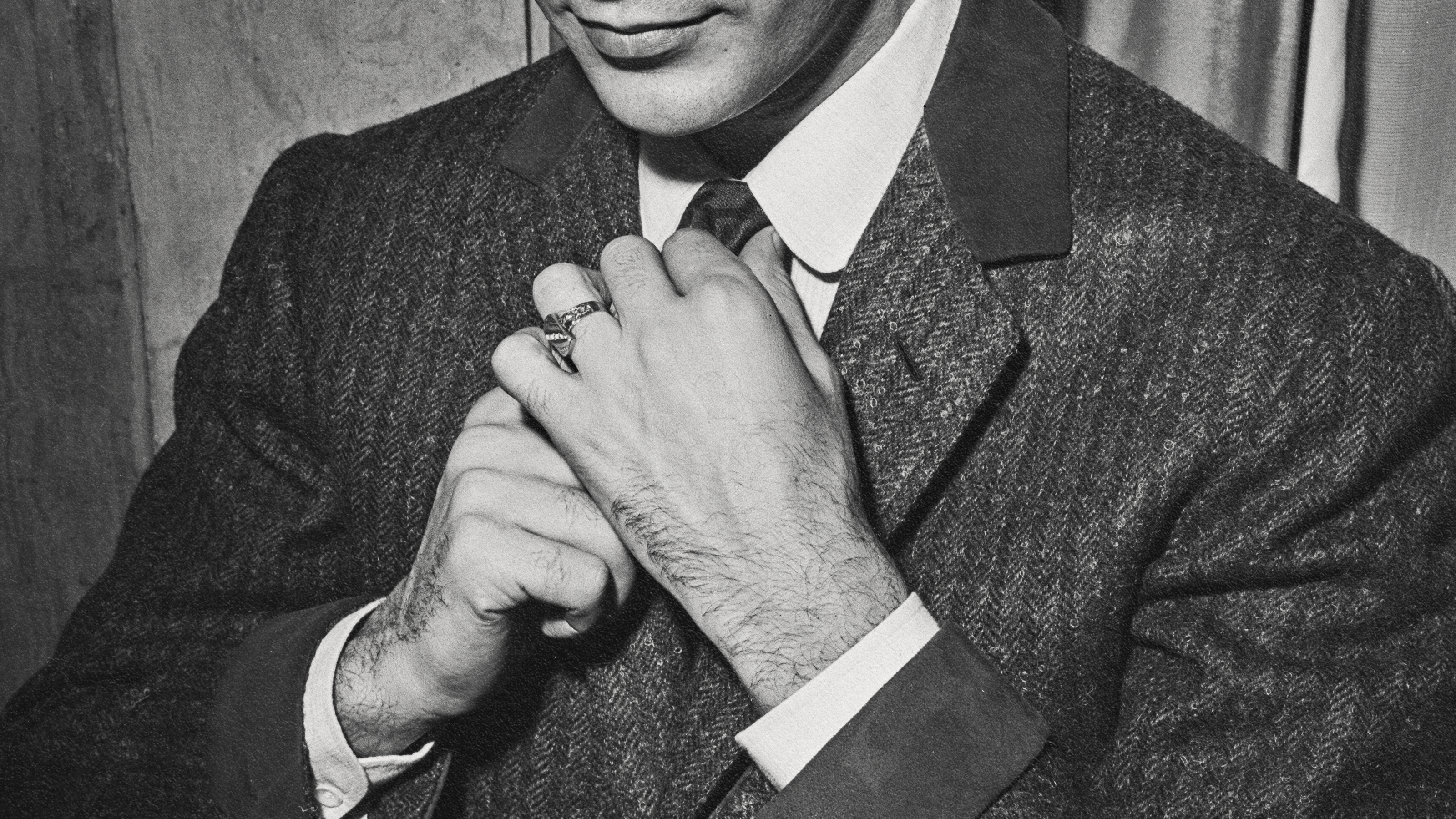 A successful man in a suit captured in a black and white photo.
