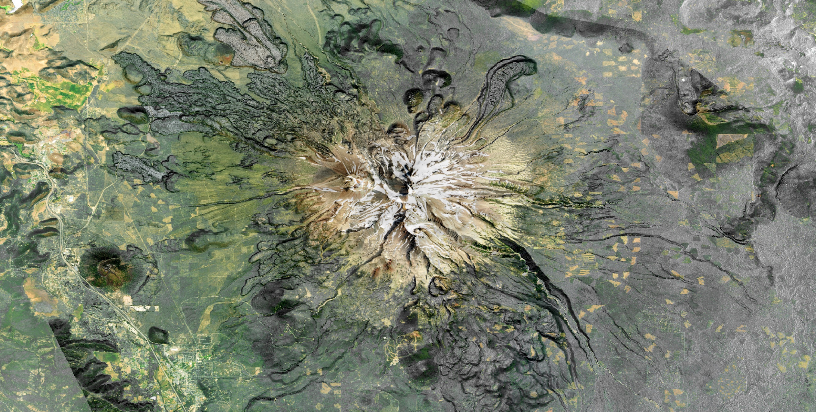 A satellite image of a mountain with a large crater.