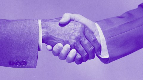Two data-smart leaders shaking hands in front of a purple background.