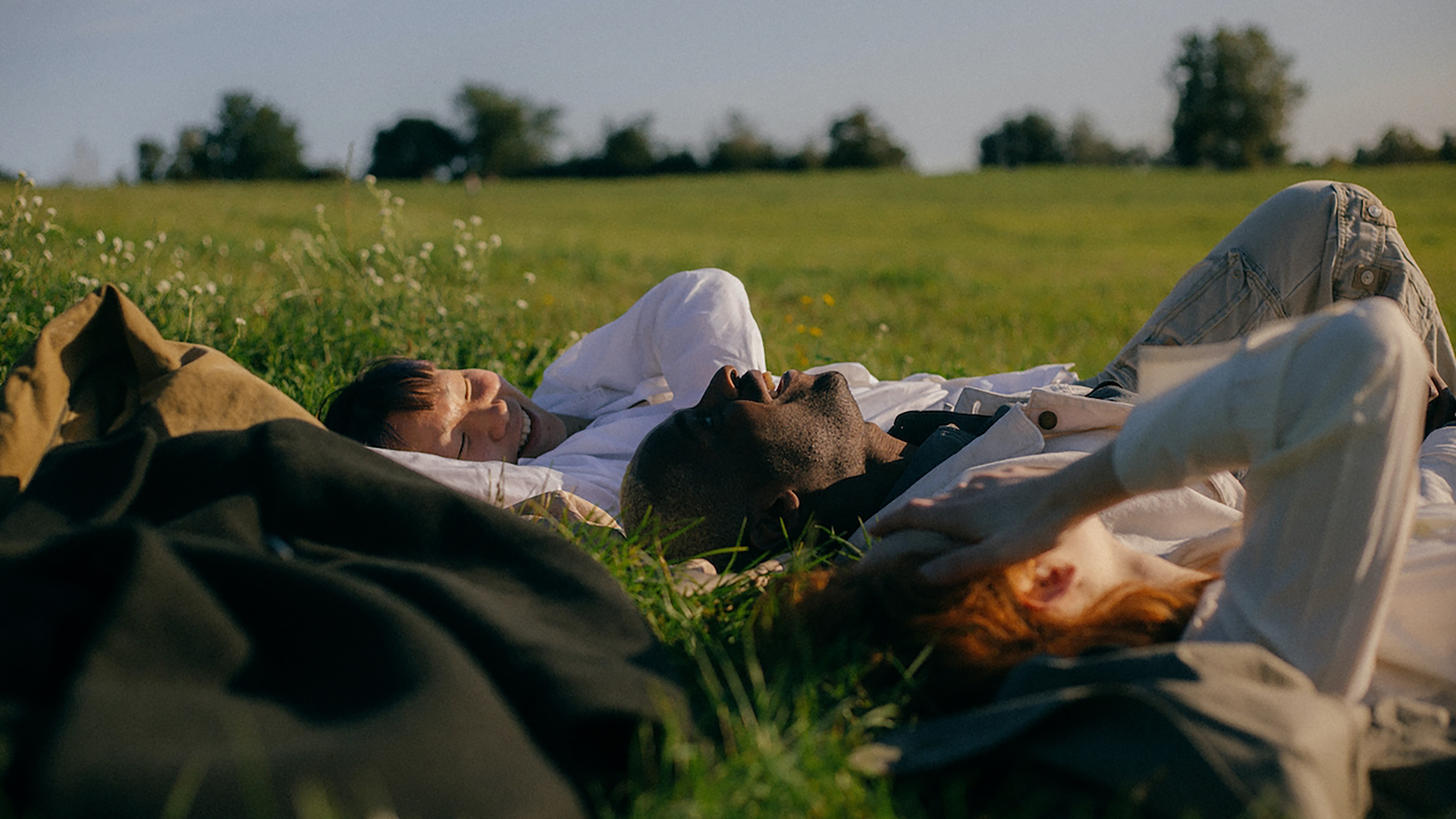 Two people laying down in a field, reflecting on their habits and contemplating their battles with depression.