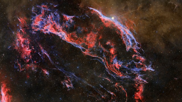 An image showcasing the captivating shape of space featuring a mesmerizing red and blue nebula.