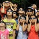 A group of children engaging in eclipse activities by wearing sunglasses and looking at the sun.