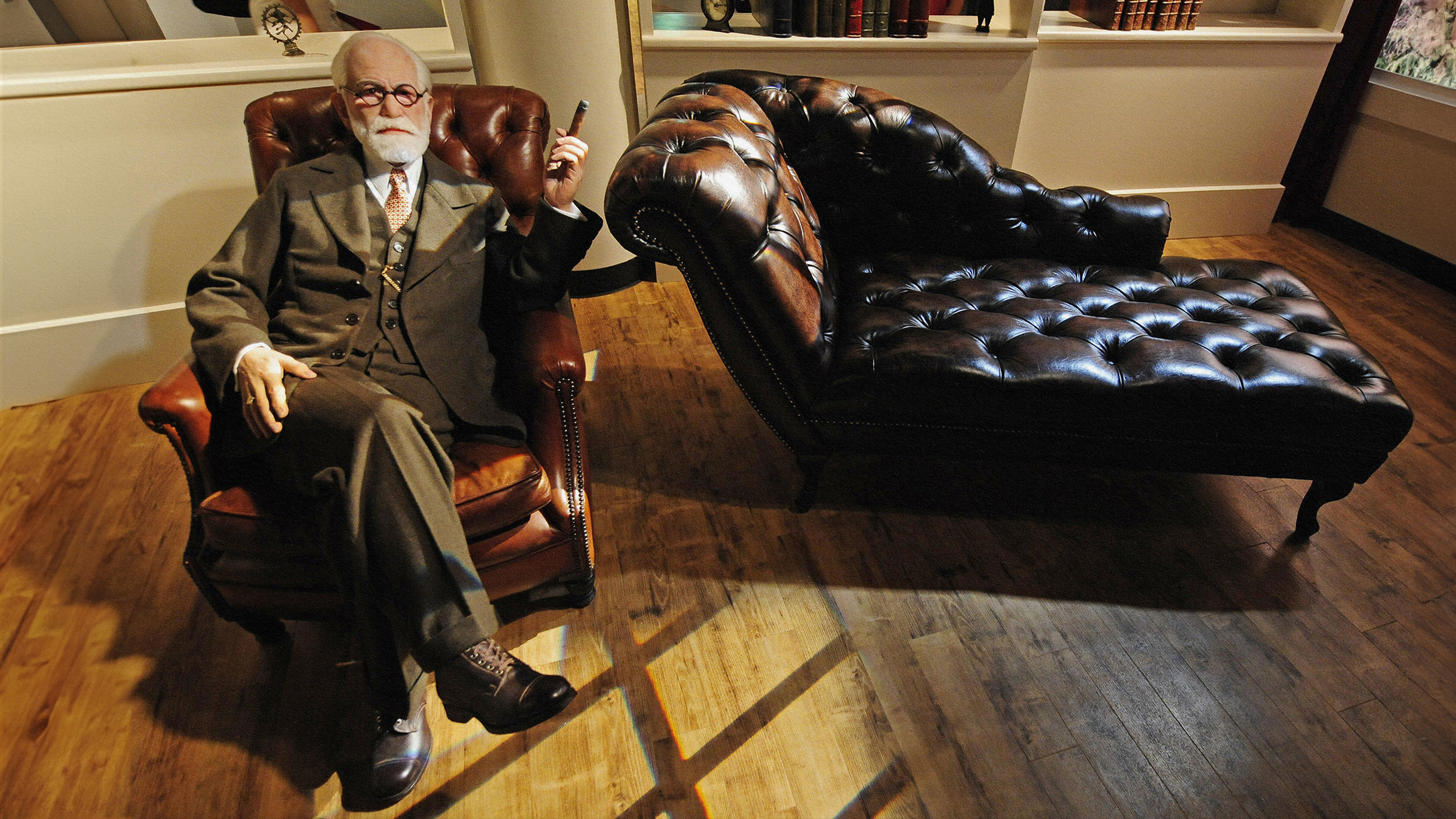 A man sitting in a leather chair, contemplating psychology.