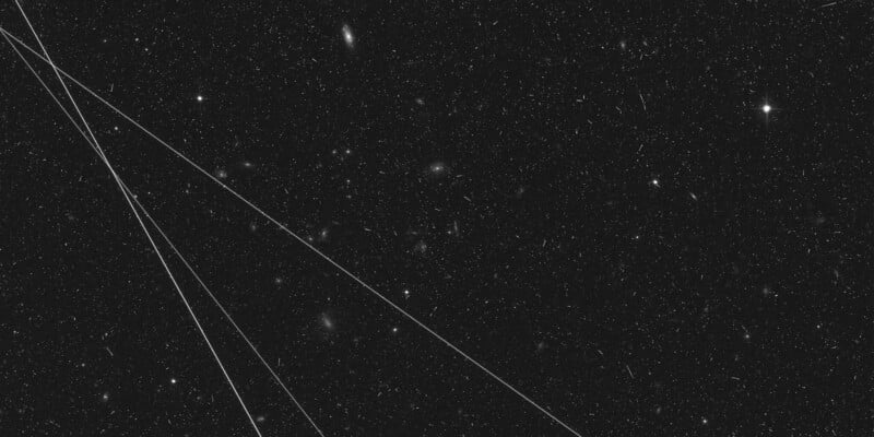 hubble image photobombed by three satellite streaks