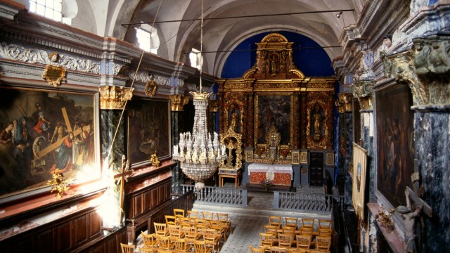 A secularized church with ornate paintings on the walls.