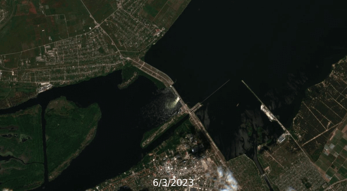 A satellite image of the Kakhovka dam along a river, showcasing a bridge in the vicinity.