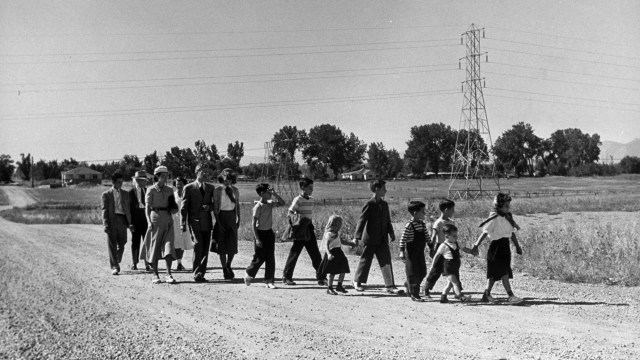 A family walking down a dirt road.