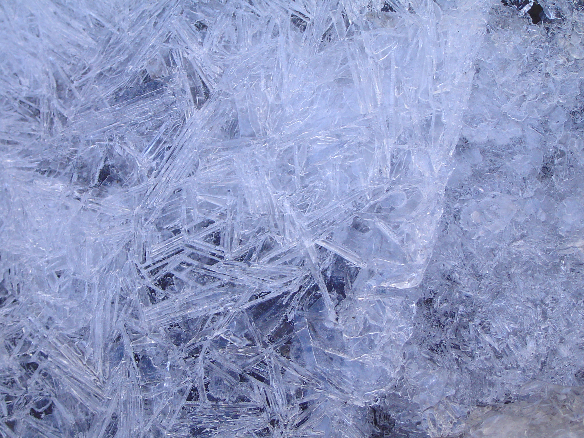 A close up of ice crystals on the ground, depicting the stunning physics of ice skating.