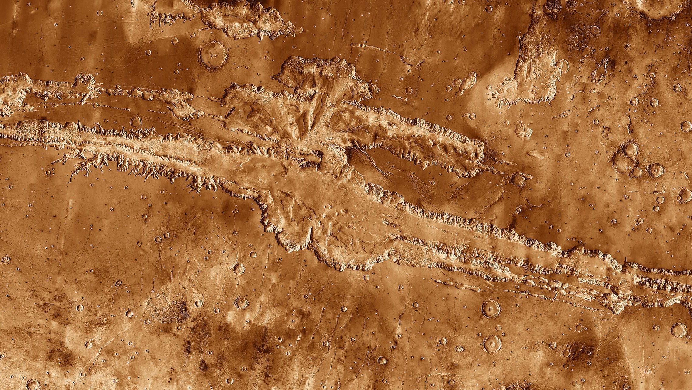 An image of the surface of Mars, showcasing its captivating and unique geological formations resembling a grand canyon.
