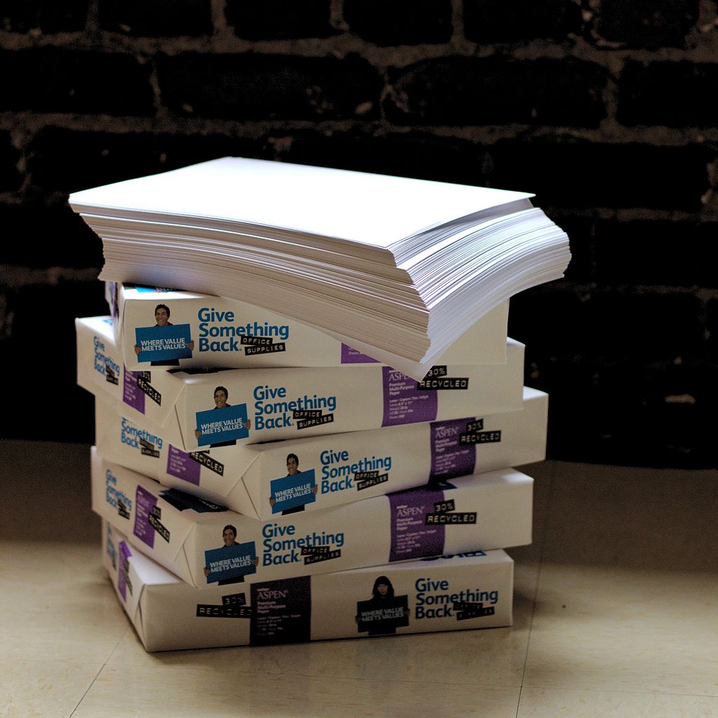 A stack of folded papers on a table.