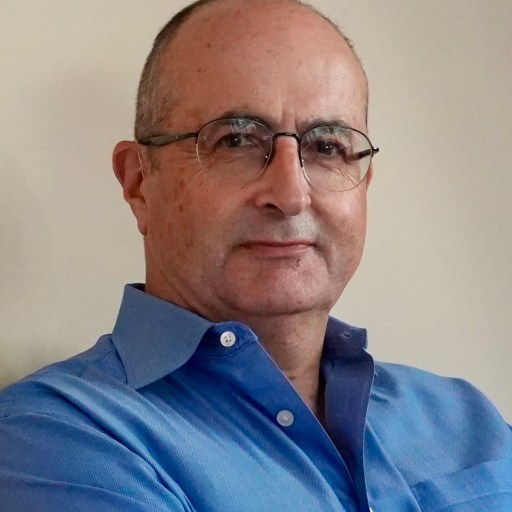 A man wearing glasses and a blue shirt.